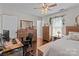 Bedroom with hardwood floors, large dresser, and a well-lit office space at 716 Mooresville Rd, Salisbury, NC 28144