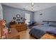 Comfortable bedroom with a blue accent wall, hardwood floors, and cozy decor at 716 Mooresville Rd, Salisbury, NC 28144
