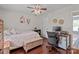 Bedroom with hardwood floors, a ceiling fan, and an office space at 716 Mooresville Rd, Salisbury, NC 28144