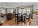 Open-concept dining area with a round table, stylish light fixture, and seamless flow to the living room at 716 Mooresville Rd, Salisbury, NC 28144