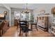 Well-lit dining area with a round table, decorative light fixture, and views of the outdoors at 716 Mooresville Rd, Salisbury, NC 28144