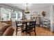 Charming dining area featuring a round wooden table, modern light fixture, and stylish decor at 716 Mooresville Rd, Salisbury, NC 28144