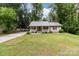 Charming home featuring a cozy front porch, lush lawn, and metal roof at 716 Mooresville Rd, Salisbury, NC 28144