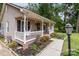 Charming home with a welcoming front porch, a hammock, and manicured landscaping at 716 Mooresville Rd, Salisbury, NC 28144