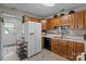Efficient kitchen layout with ample cabinet space, white refrigerator, and convenient access to laundry at 716 Mooresville Rd, Salisbury, NC 28144