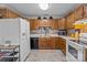 Compact kitchen featuring wood cabinetry, essential appliances, and a functional design at 716 Mooresville Rd, Salisbury, NC 28144