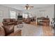 Cozy living room with leather furniture, a piano, and natural light at 716 Mooresville Rd, Salisbury, NC 28144