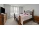 Cozy bedroom featuring an ornate bed frame, a large window, and carpeted floors at 718 Dillon Way # 38, Fort Mill, SC 29715