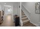 Hallway featuring stairs, vinyl flooring, with a storage unit, with an ornate metal wall hanging at 718 Dillon Way # 38, Fort Mill, SC 29715