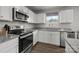 Modern kitchen featuring stainless steel appliances, granite countertops, ample cabinet space, and a window over the sink at 718 Dillon Way # 38, Fort Mill, SC 29715