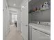 Bright laundry area with white washer and dryer, shelf storage with supplies, and access to bedroom at 718 Dillon Way # 38, Fort Mill, SC 29715