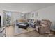 Spacious living room featuring a comfortable couch, recliner, ottoman, large windows, and a stylish rug at 718 Dillon Way # 38, Fort Mill, SC 29715