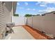 Cozy patio with a concrete slab, white fence, grill, and mulch; perfect for outdoor entertaining at 718 Dillon Way # 38, Fort Mill, SC 29715