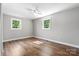 Large bedroom featuring wood flooring, a ceiling fan, and lots of natural light through large windows at 73 20Th Sw Ave, Hickory, NC 28602