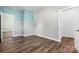 Spacious bedroom featuring clean trim, wood flooring, neutral paint, and beadboard accent wall at 73 20Th Sw Ave, Hickory, NC 28602