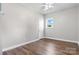 Bright bedroom showcasing wood flooring, a ceiling fan, natural light, and clean white trim at 73 20Th Sw Ave, Hickory, NC 28602