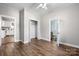 Bedroom featuring wood flooring, a closet, a ceiling fan, and view to a renovated bathroom at 73 20Th Sw Ave, Hickory, NC 28602