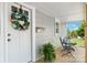 Close up of cozy front porch with seating and decorative wreath on white front door at 73 20Th Sw Ave, Hickory, NC 28602