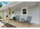 Cozy front porch with seating, plants and decorative wreath on front door of charming home at 73 20Th Sw Ave, Hickory, NC 28602