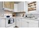 Close up of bright kitchen featuring white cabinets, hardwood floors and a stainless steel sink at 73 20Th Sw Ave, Hickory, NC 28602