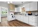 Bright kitchen featuring white cabinets, gray backsplash and hardwood floors at 73 20Th Sw Ave, Hickory, NC 28602