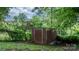 Utility shed in the backyard surrounded by trees and greenery, providing extra storage space at 73 20Th Sw Ave, Hickory, NC 28602