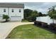 Well-maintained backyard featuring a paved driveway, lush green grass, and a privacy fence creating a serene outdoor space at 734 Herlong Ave, Rock Hill, SC 29732