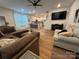 Bright and airy living room featuring hardwood floors, comfortable seating, and abundant natural light from large windows at 734 Herlong Ave, Rock Hill, SC 29732