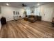 Stylish living room featuring hardwood floors, comfortable seating arrangements, and a modern ceiling fan, filled with light at 734 Herlong Ave, Rock Hill, SC 29732