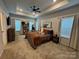 Spacious main bedroom with a tray ceiling, plush carpet, and large windows for natural light and comfortable furniture at 734 Herlong Ave, Rock Hill, SC 29732