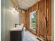 Bathroom in need of remodeling, showing a new vanity and exposed walls at 828 N Main St, Mount Pleasant, NC 28124
