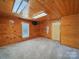 Bedroom with wood paneled walls, lots of natural light, and neutral carpet at 828 N Main St, Mount Pleasant, NC 28124