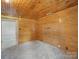 Bedroom with wood paneled walls, lots of natural light, and neutral carpet at 828 N Main St, Mount Pleasant, NC 28124