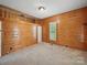Bedroom featuring a loft area, wood-paneled walls, and natural light at 828 N Main St, Mount Pleasant, NC 28124