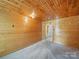Bedroom with wood paneled walls, lots of natural light, and neutral carpet at 828 N Main St, Mount Pleasant, NC 28124