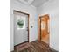 Entryway with wood floors, showing the front door and adjacent doorway, with cottage charm at 828 N Main St, Mount Pleasant, NC 28124