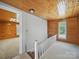 Hallway with wood paneled walls, stairs, and neutral carpet at 828 N Main St, Mount Pleasant, NC 28124