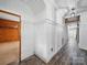 Hallway featuring wood floors, with charming wood-paneled walls and cottage-style architecture at 828 N Main St, Mount Pleasant, NC 28124