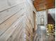 Hallway featuring wood-paneled accent wall and staircase leading to upper level at 828 N Main St, Mount Pleasant, NC 28124