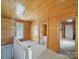 Inviting living room with wood paneled walls, lots of natural light, and neutral carpet at 828 N Main St, Mount Pleasant, NC 28124