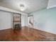 Living room with fireplace, hardwood floors and a view of the staircase to the upper level at 828 N Main St, Mount Pleasant, NC 28124