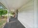 Inviting front porch features a comfortable wicker chair and a welcoming, relaxing ambiance at 828 N Main St, Mount Pleasant, NC 28124