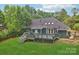 Expansive backyard with a large wooden deck, perfect for outdoor entertaining, nestled in a private, wooded setting at 8338 Rittenhouse Cir, Charlotte, NC 28270