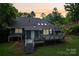 Backyard view of home with deck, skylights, and landscaped lawn at 8338 Rittenhouse Cir, Charlotte, NC 28270