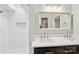 Bathroom with a double vanity, white tiled shower and a skylight at 8338 Rittenhouse Cir, Charlotte, NC 28270
