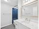 Bathroom featuring a blue tiled shower, vanity, and a large framed mirror at 8338 Rittenhouse Cir, Charlotte, NC 28270