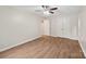 Bedroom featuring wood flooring, a ceiling fan, closet and door at 8338 Rittenhouse Cir, Charlotte, NC 28270