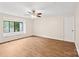 Bedroom featuring wood flooring, a ceiling fan, and large windows with window seats for natural light at 8338 Rittenhouse Cir, Charlotte, NC 28270