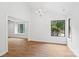 Bright dining room featuring wood flooring, a chandelier, and large windows for natural light at 8338 Rittenhouse Cir, Charlotte, NC 28270