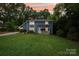 Charming blue two-story home featuring a cozy front porch and lush green lawn at 8338 Rittenhouse Cir, Charlotte, NC 28270